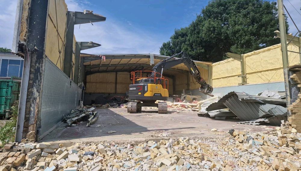 Background image of commercial building being demolished on construction site.