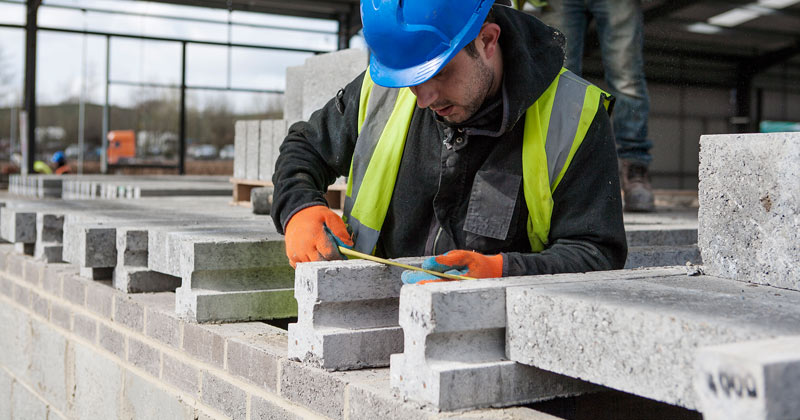 Photo of commercial design and build contractors measuring building blocks