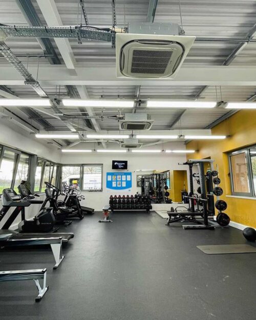 Featured image of gym interior. Steel frame building with exposed ventilation.