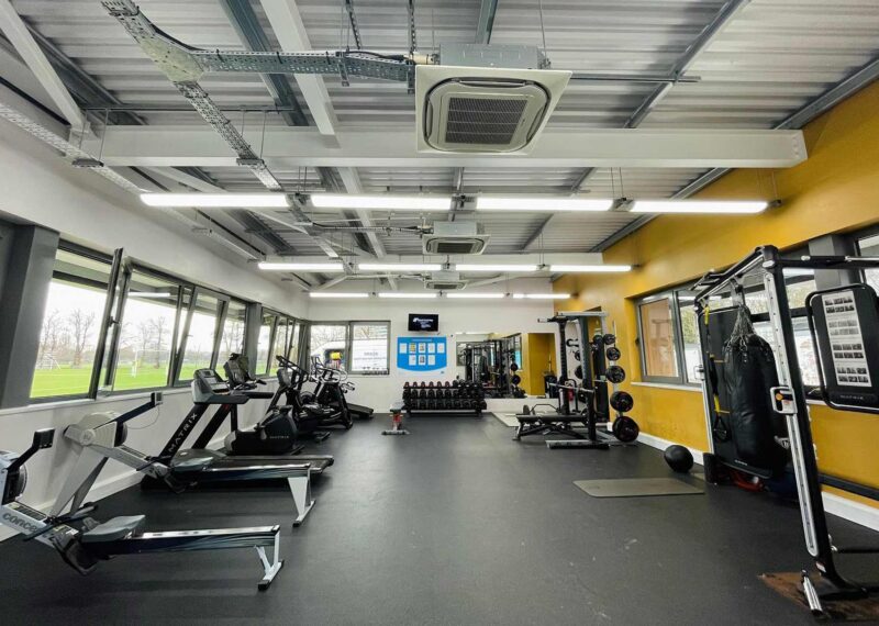 Featured image of gym interior. Steel frame building with exposed ventilation.