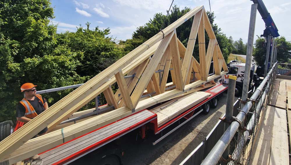 Image of construction contractor signing off delivery of timber frame