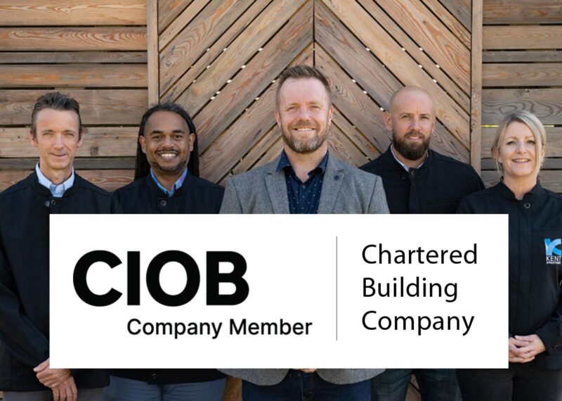 Image of staff members with banner promoting membership to the CIOB as a Chartered Building Company