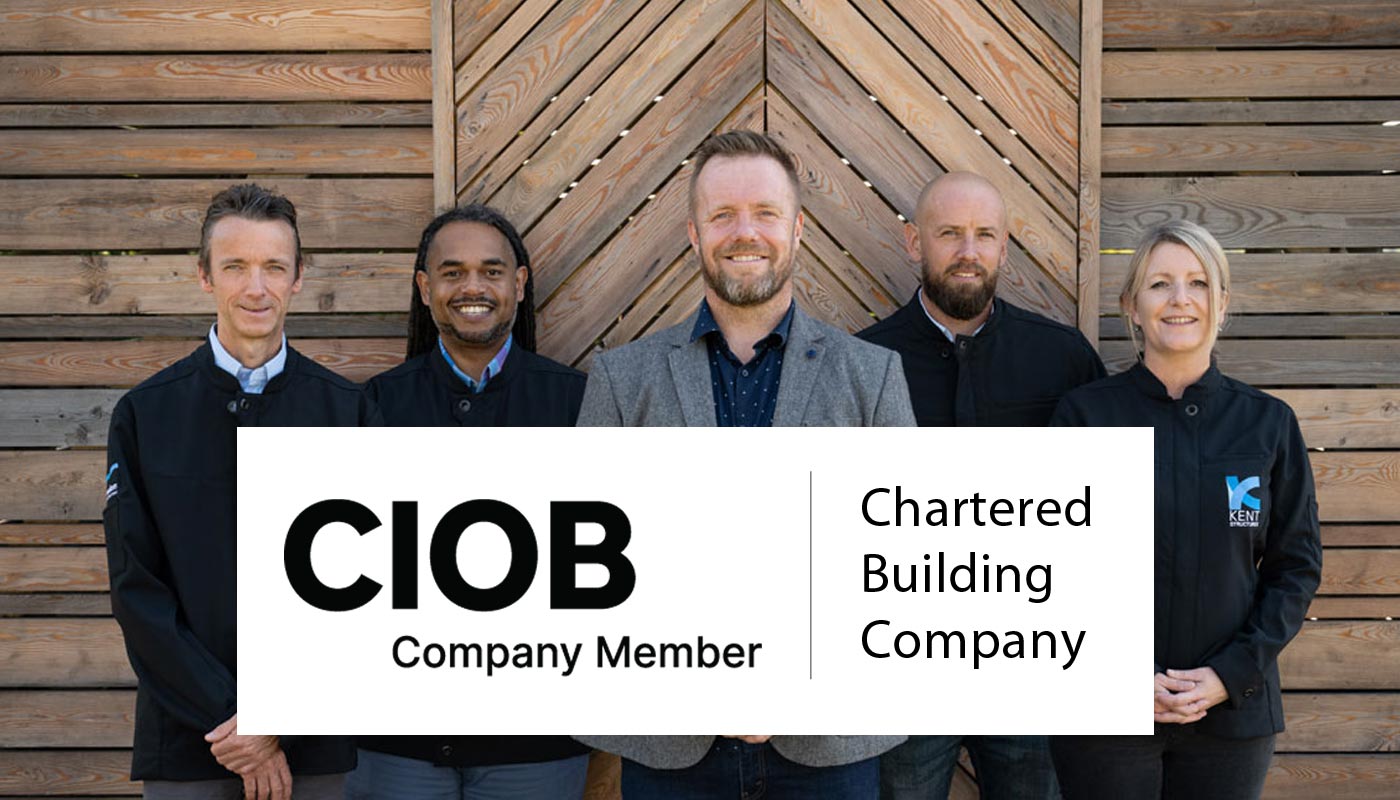 Image of staff members with banner promoting membership to the CIOB as a Chartered Building Company
