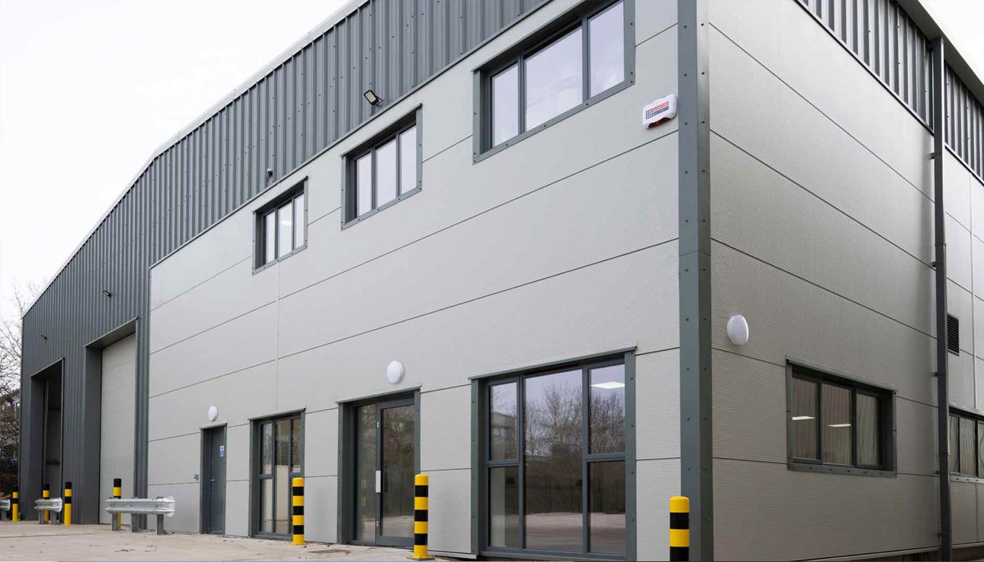 News image of modern Opak Ltd warehouse building with grey metal cladding.