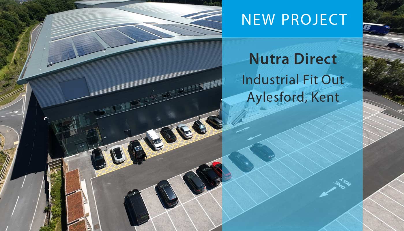Aerial of large industrial warehouse building with parking, overlaid with text 'New Project - Nutra Direct, Industrial Fit Out, Aylesford, Kent